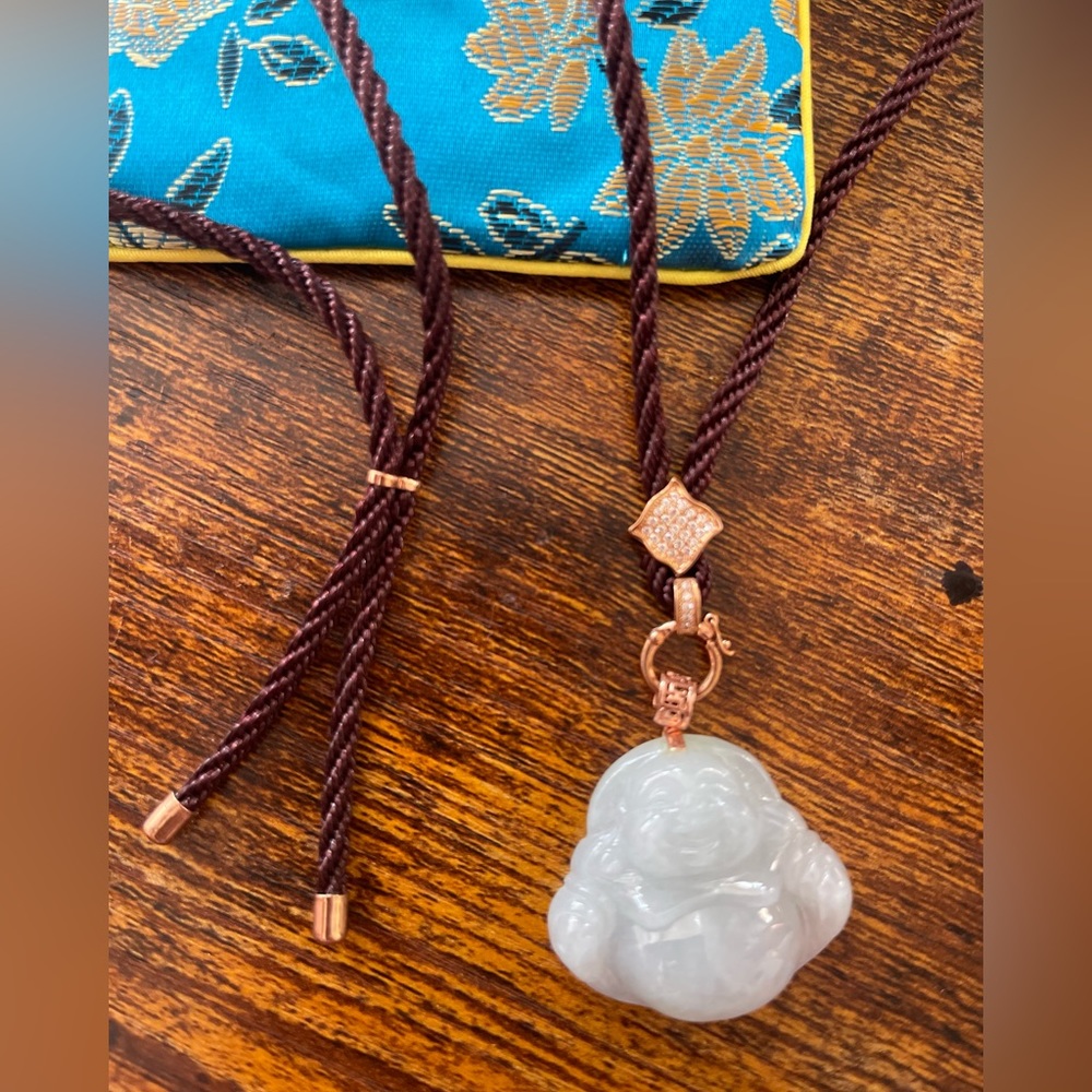 Carved jade Buddha pendant on silk cord with gold plated accents